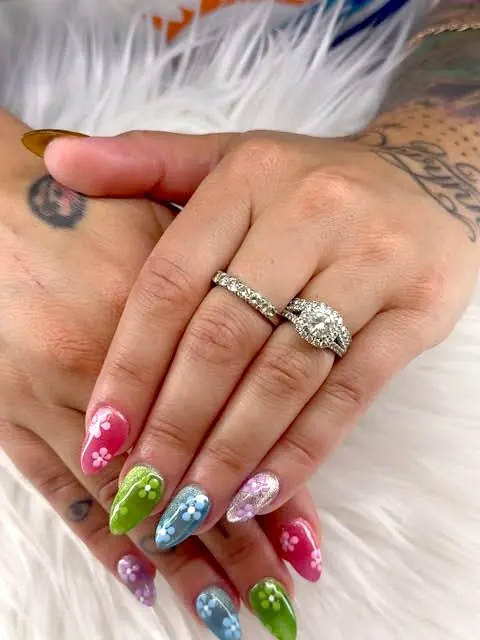 Pink, green and blue nails with painted flowers