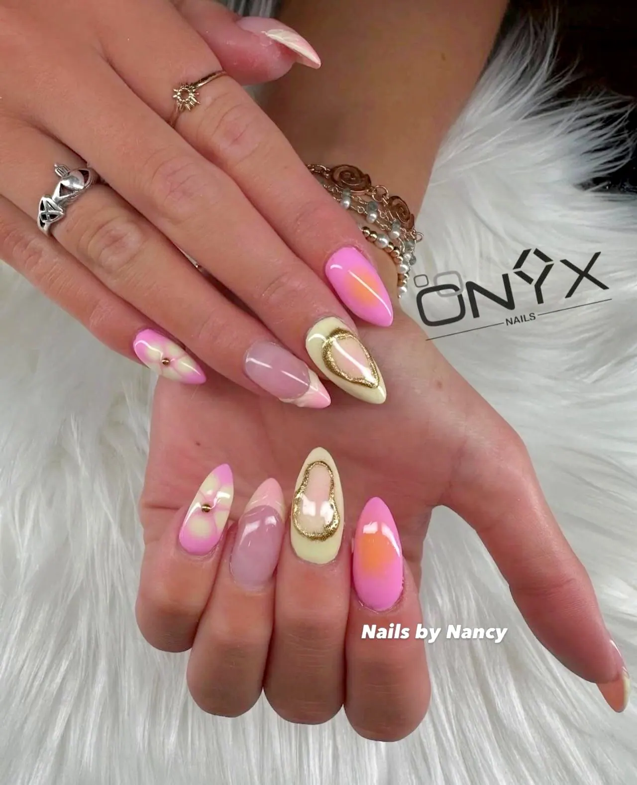 Pink and cream almond nails with gold heart accents