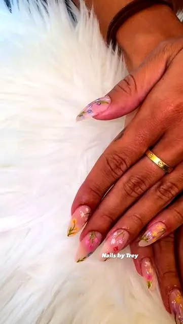 Sheer nude almond nails with hand-painted wildflowers