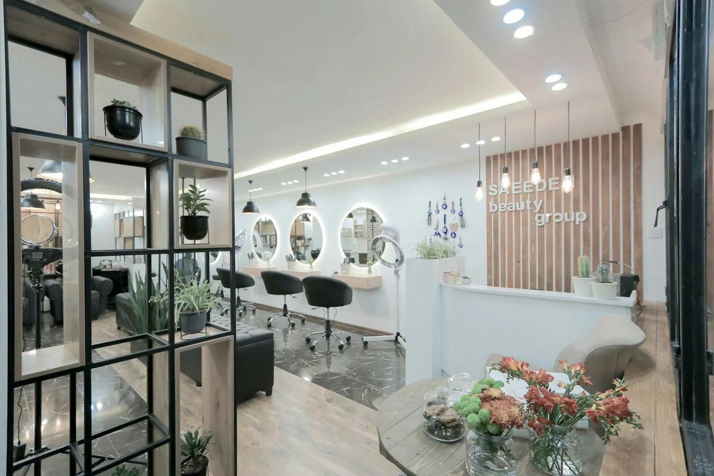 Bright, modern salon interior with white chairs and round mirrors