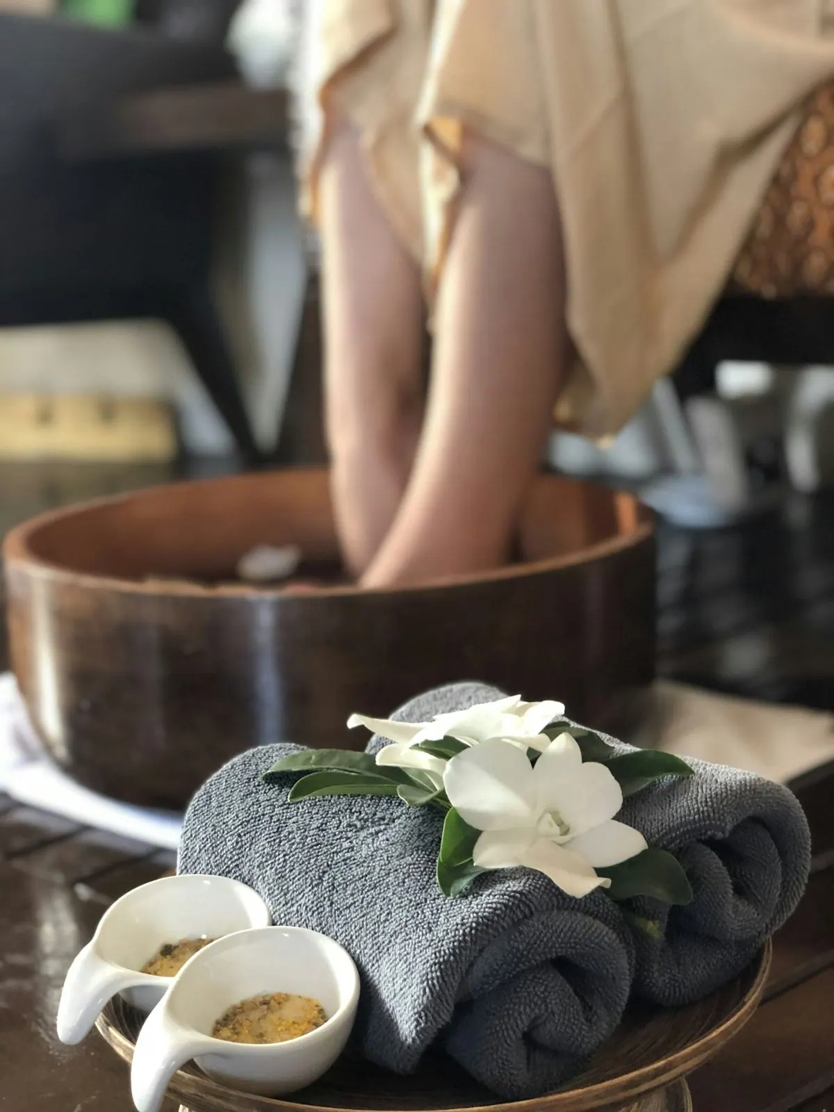Wooden foot soak bowl with towels and flowers